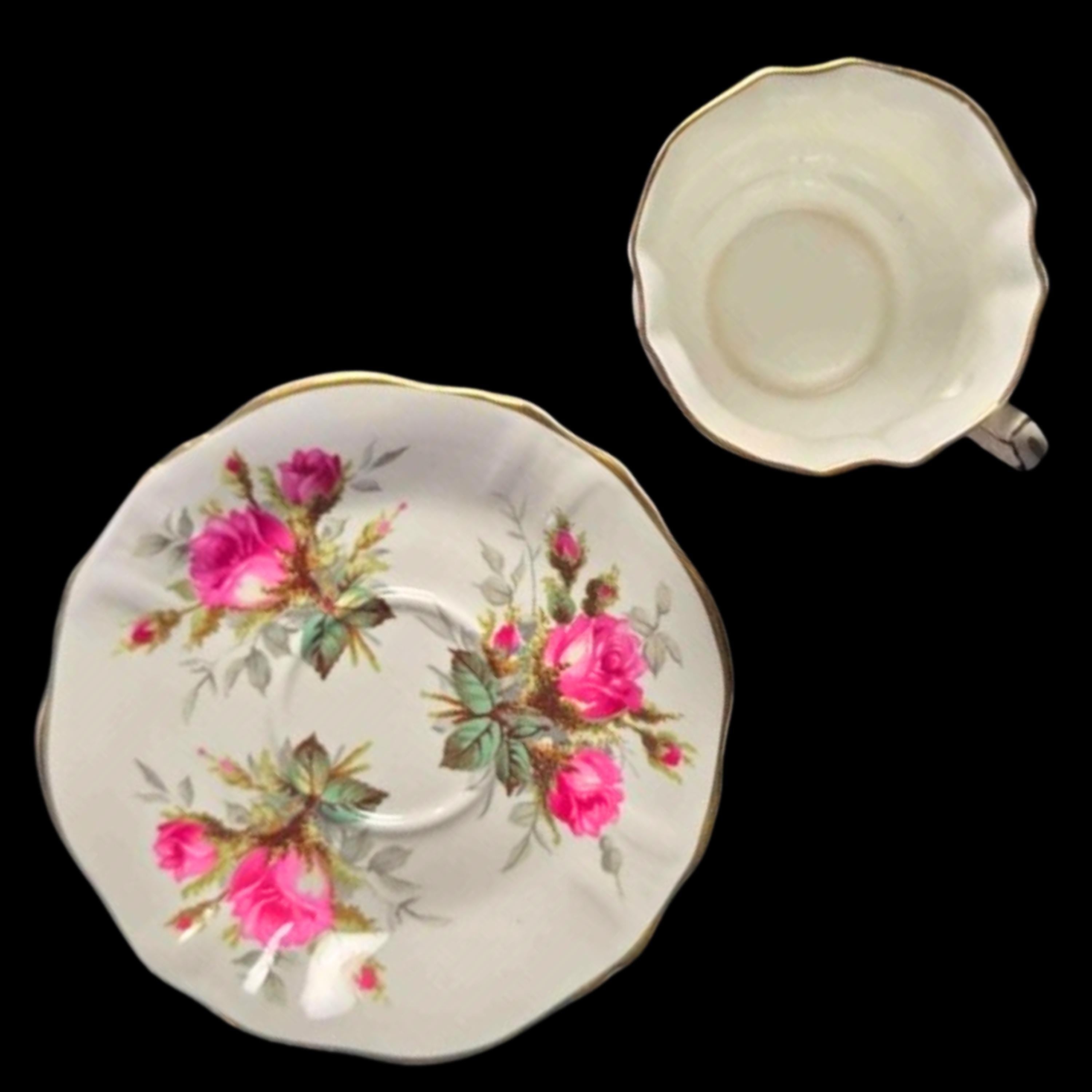 Teacup and saucer with floral design on a white background