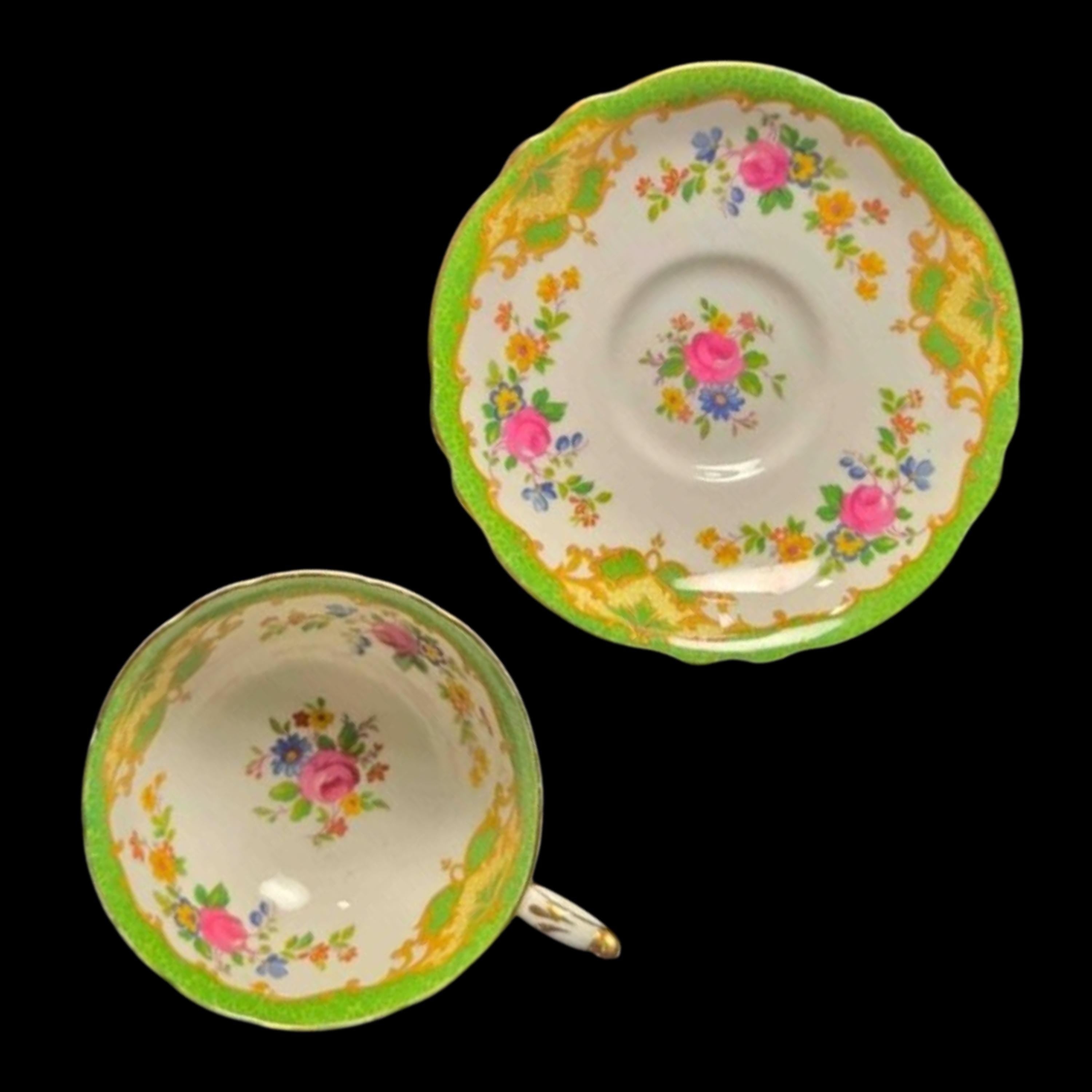 Floral teacup and saucer set on a black background