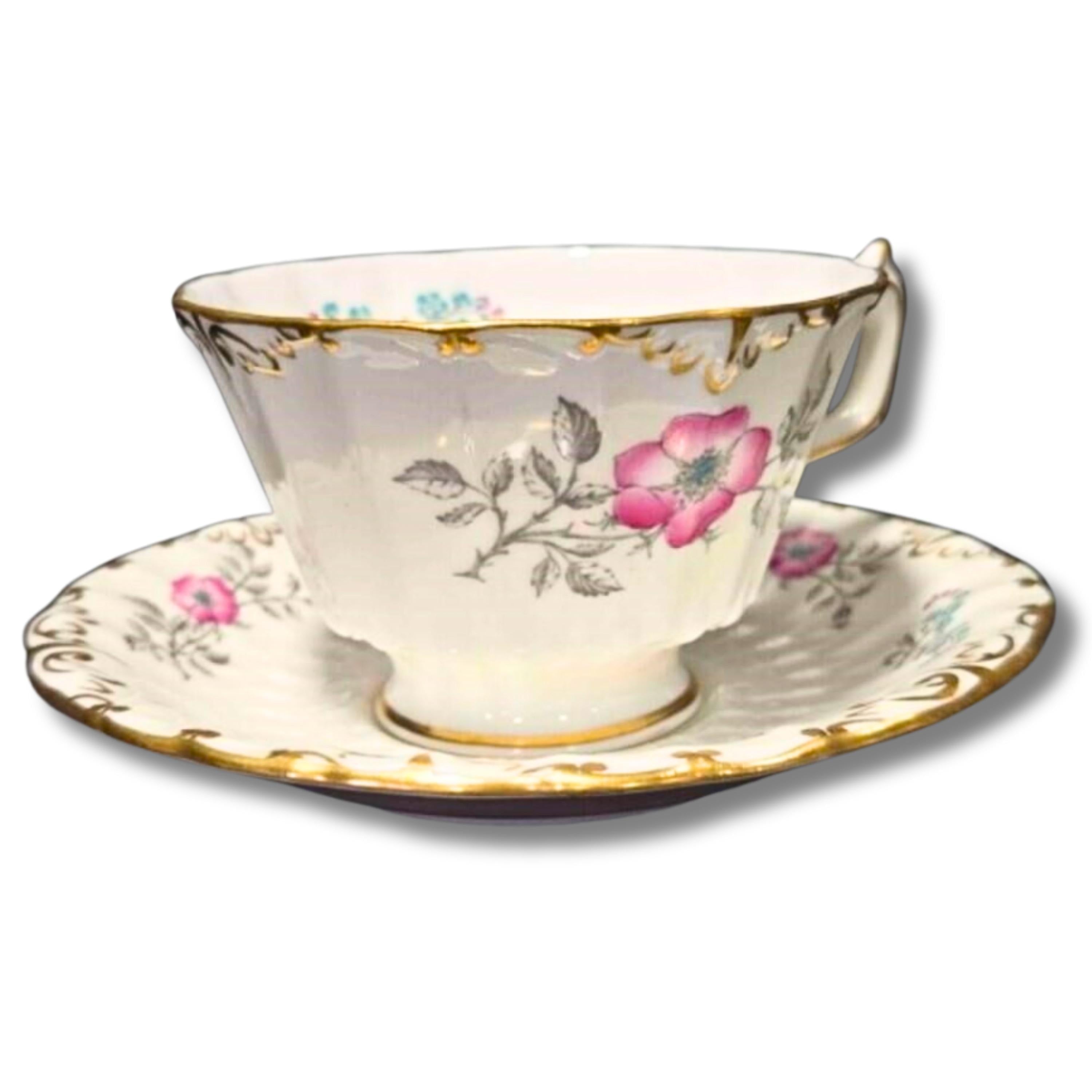 Teacup and saucer with floral design on a white background