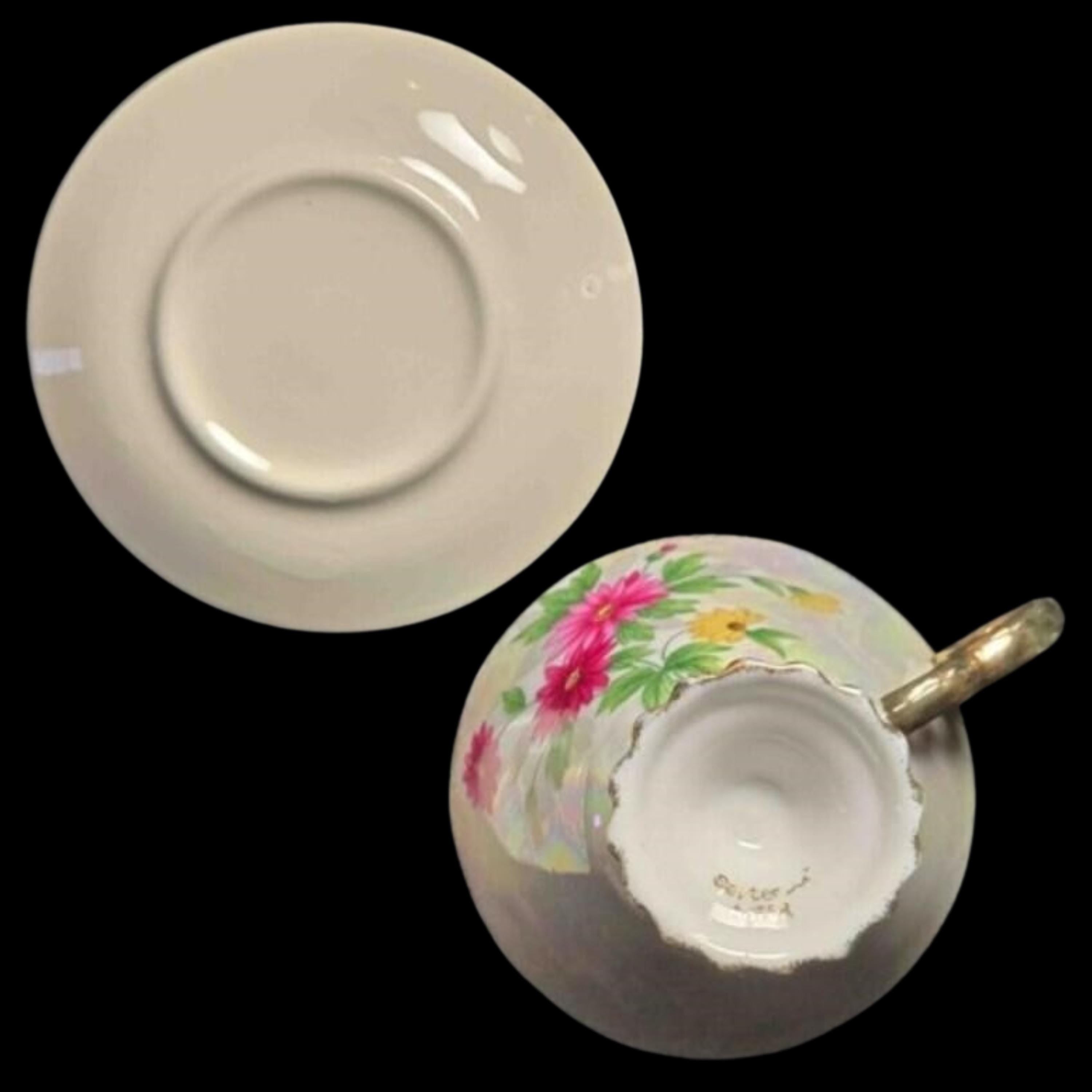 Teacup with floral design and saucer on a black background